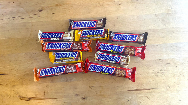 A variety of Snickers bars on a table.