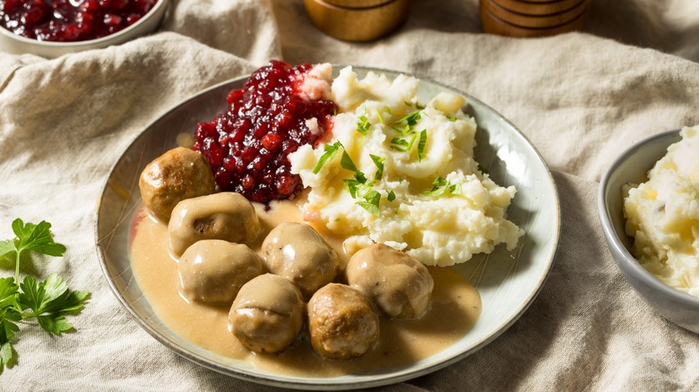 Traditional Swedish meatballs in gravy with mashed potatoes and lingonberry jam