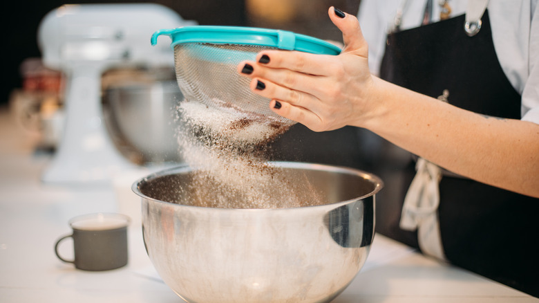 Sifting spices into dough