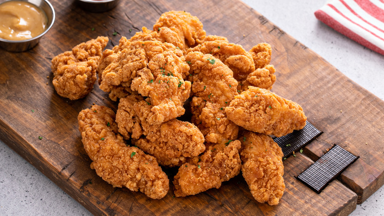 A stack of chicken fingers on platter