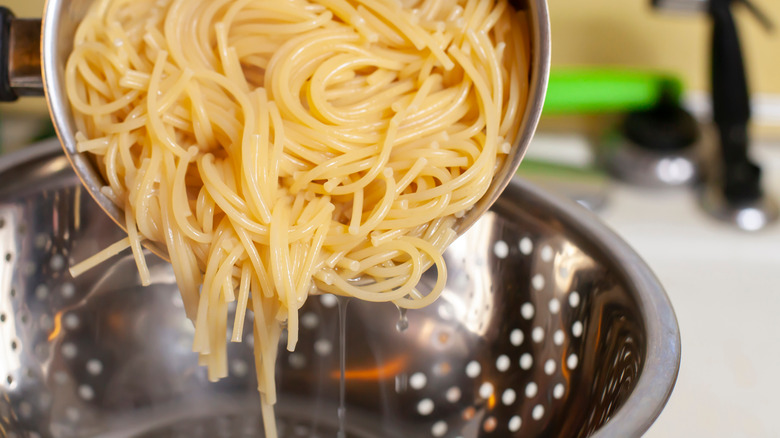 Straining pasta in colander