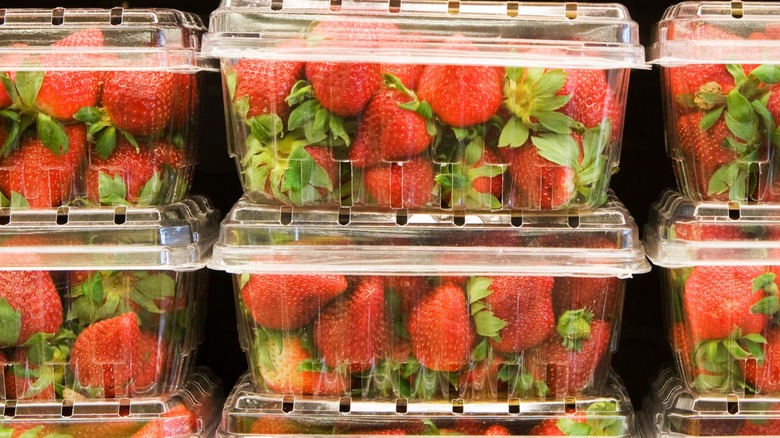 Strawberries in plastic cartons at grocery store