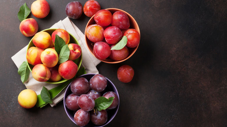 Three bowls full of stone fruits