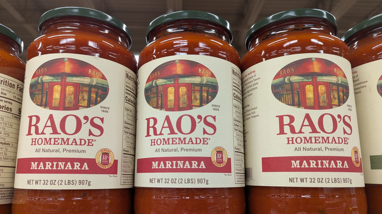 Line of Rao's marinara sauce jars lined at grocery store.