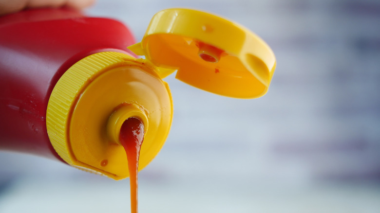 A close-up of a ketchup Bottle that has an open lid ready to use for dipping and adding flavor
