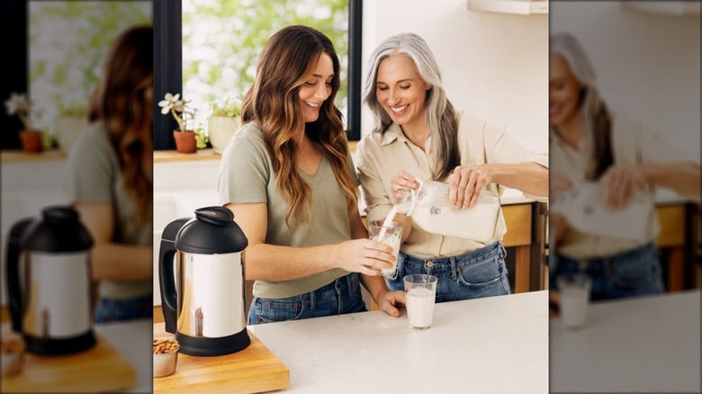 Two people using the Almond Cow Complete Plant-Based Milk System from Costco.