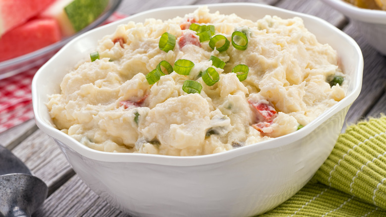Creamy potato salad in a white ceramic bowl