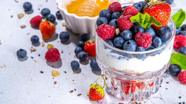 Berry parfait with honey in a ramekin.