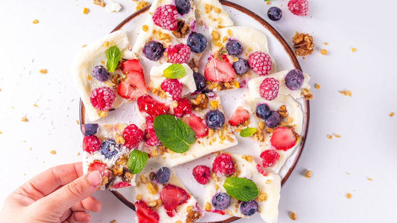 White yogurt bark with various berries on top.