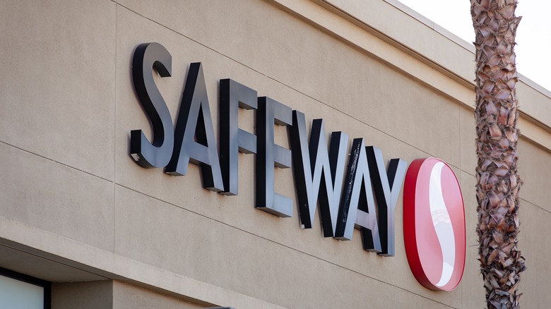 Safeway store sign with palm tree trunk