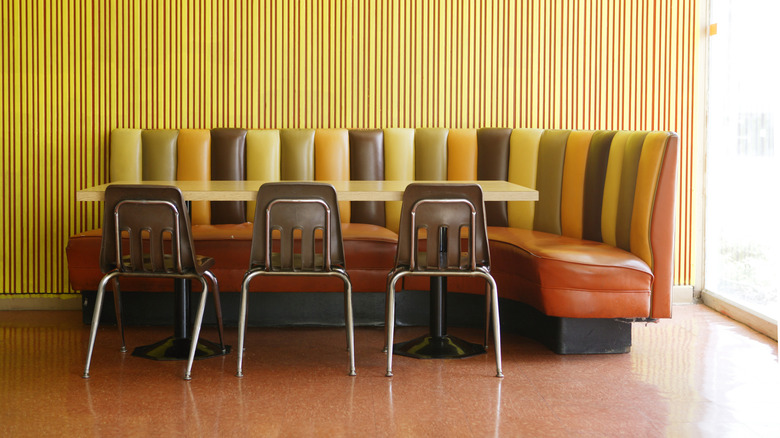 Retro-style breakfast nook with table, bench, and chairs
