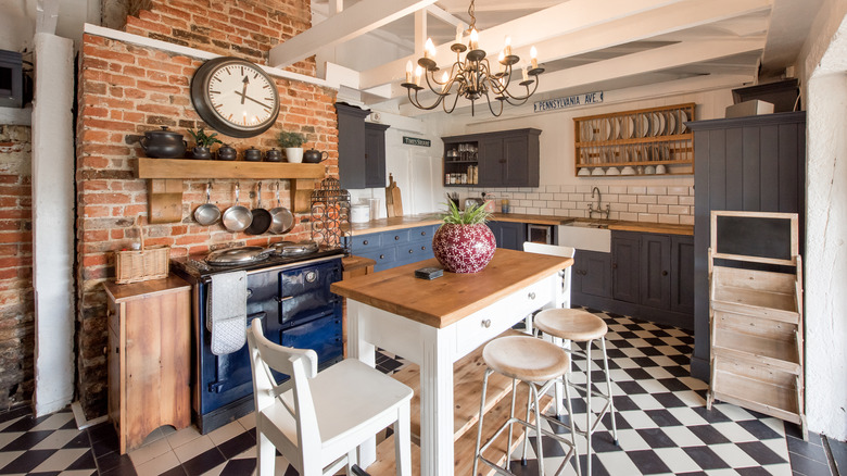Eclectic kitchen featuring mismatched furniture and cabinets