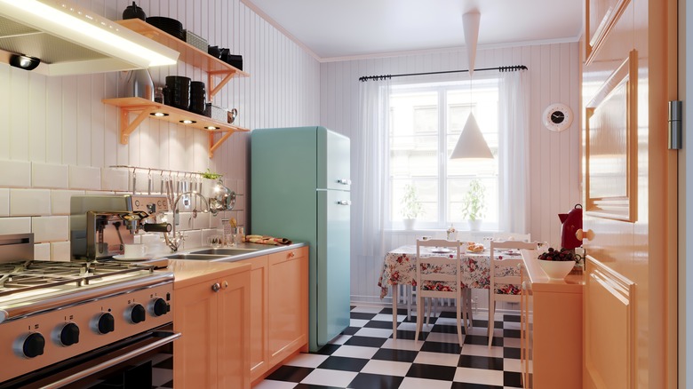 Pink kitchen with blue refrigerator and checkered flooring