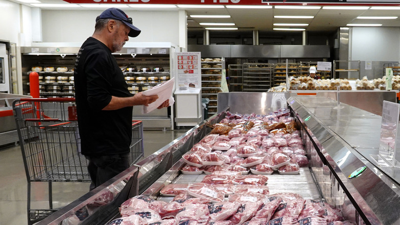 A customer shopping for meat at a Costco