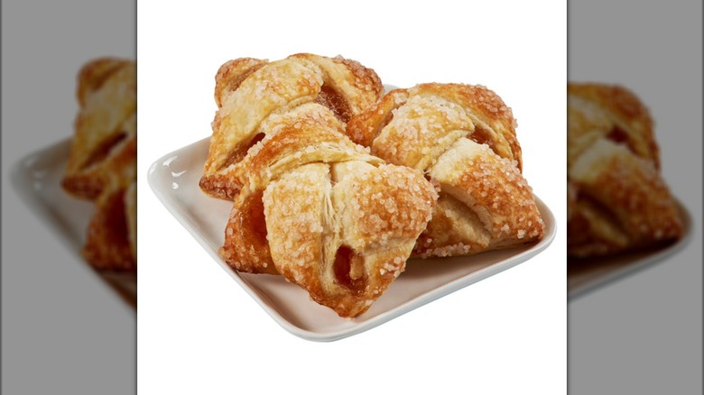 Three Kirkland Signature Caramel Apple Strudel Bites sit on a plate.