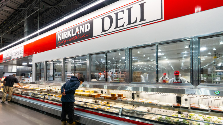 A customer shops at a Costco deli section.
