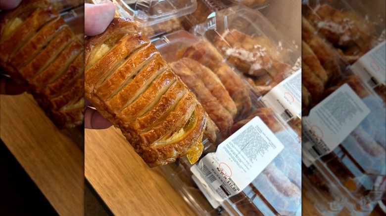 A hand holds a Kirkland Signature Peaches and Cream Pastry.