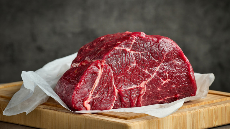 Raw beef on a wooden board.