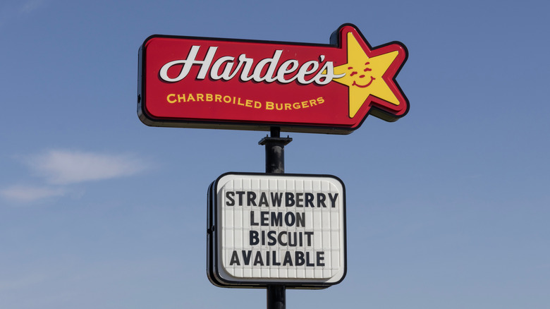 The Hardee's sign against a clear blue sky