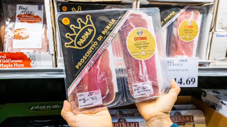 hands holding up a pack of citterio prosciutto di parma at Costco