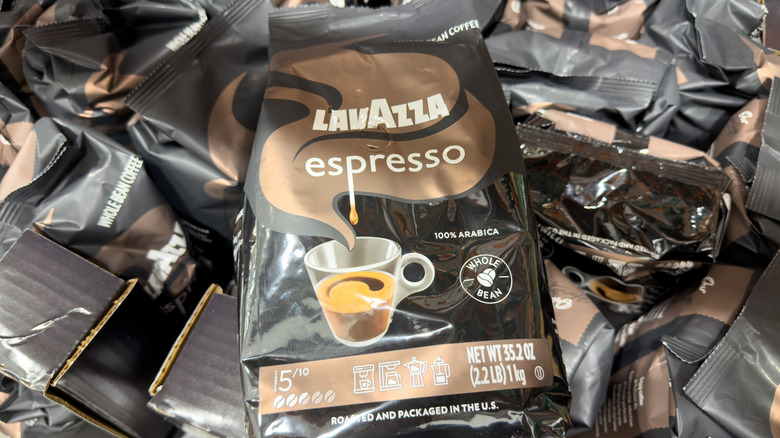 bag of lavazza whole bean espresso coffee on top of several other bags