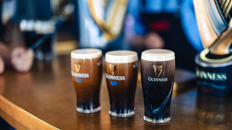 Pints of Guinness poured and displayed on bar.