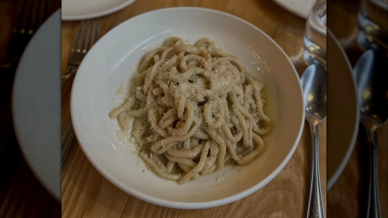 Pasta is served in a bowl.