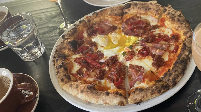 Pizza is served on a plate.