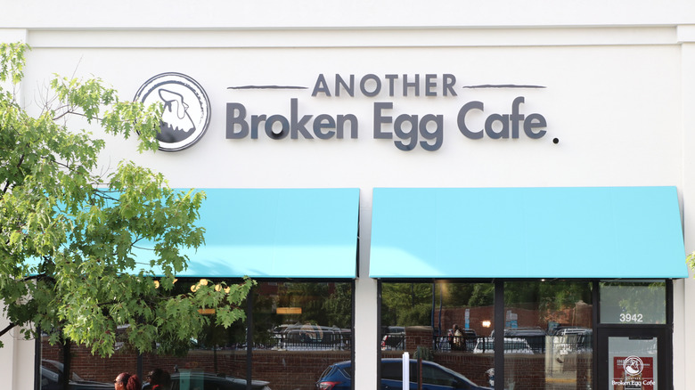 The exterior of Another Broken Egg Cafe with blue awnings