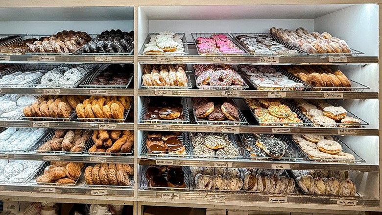 A simple doughnut case displaying dozens of different kinds of doughnuts