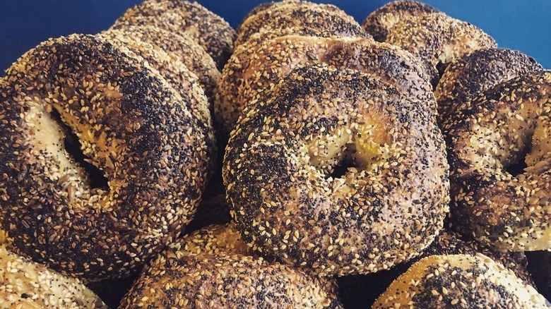 Stacks of fresh, poppy and sesame seed sourdough bagels on display at Scratch