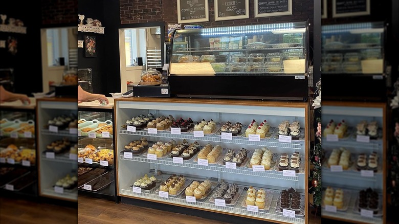 Mystic Sugar Bakery's pastry case displaying various trays of different cupcake flavors