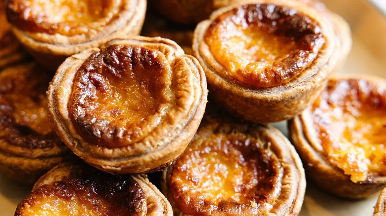 A stacked pile of Boulted Bread's fresh-baked Pasteis de Nata (egg custard tarts)