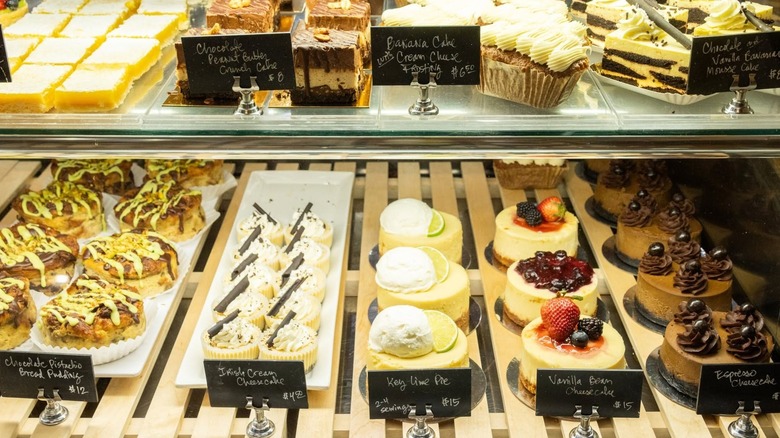 A photo of a display case at Nichole's Fine Pastry filled with various small cakes and pastries