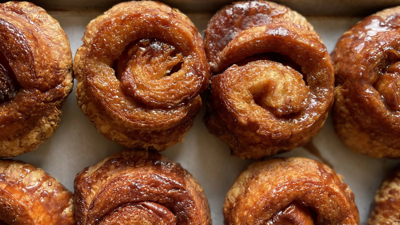 A tray of sweet, sticky buns from Bakeshop laid out in two neat rows