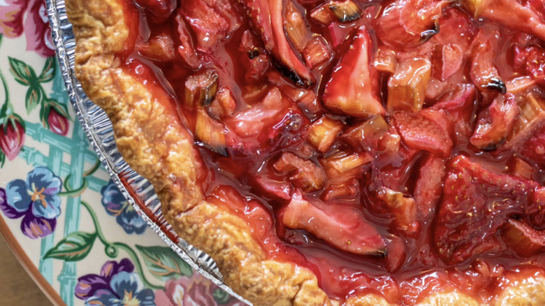 Zoomed-in photo of a floral, ceramic plate displaying a strawberry-rhubarb pie from Red Truck Bakery