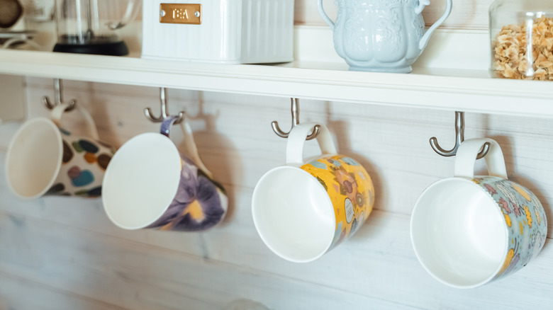 Hanging coffee mugs under shelf