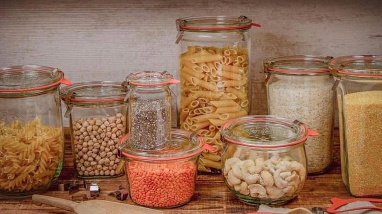 Different sizes of Weck jars are filled with various dry goods, from pasta to rice to beans