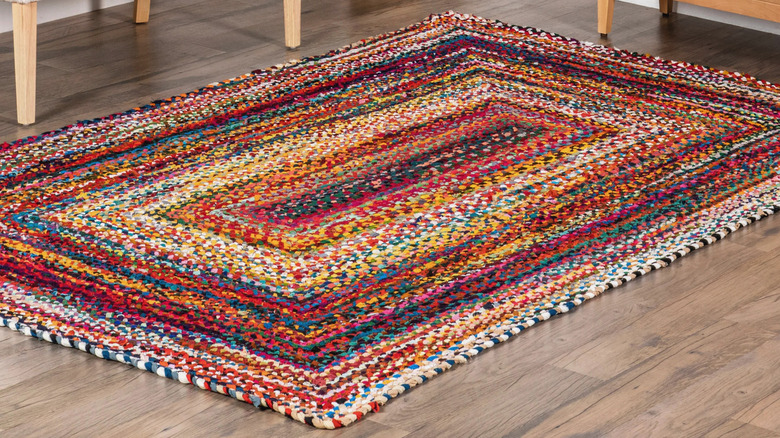 Colorful braided rug on wood floor