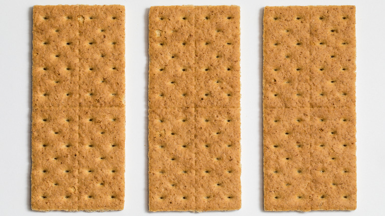 Three whole graham crackers white background