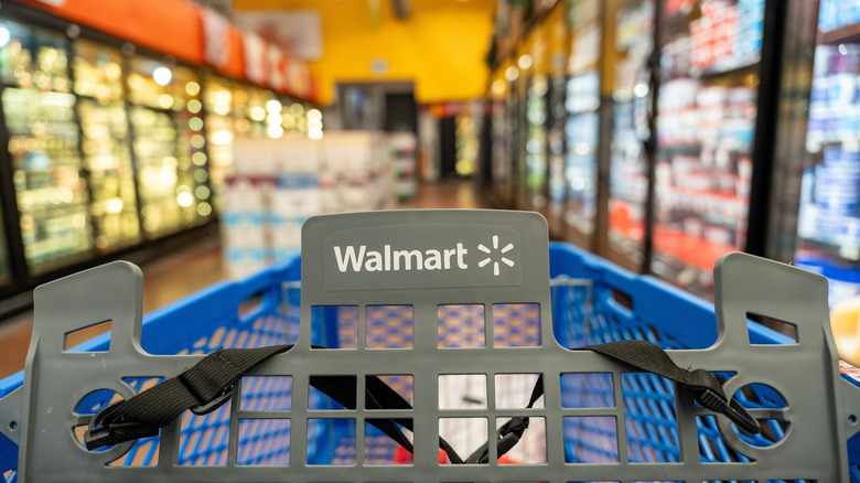 A Walmart shopping cart in a freezer aisle