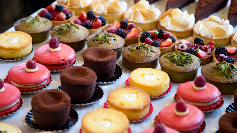 Assorted colorful small cakes in rows