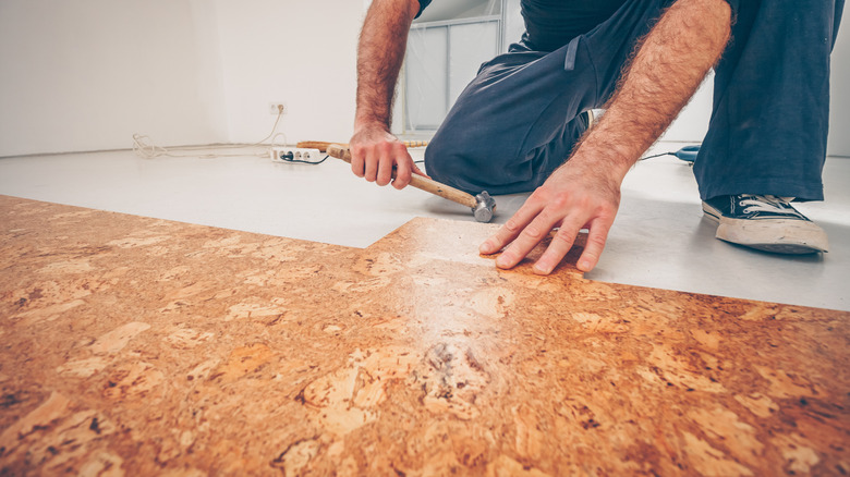 A master craftsman installs a cork floor.