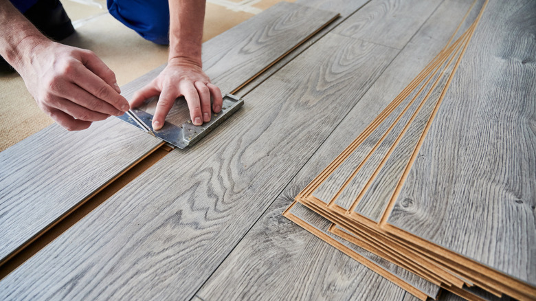 Someone installing laminate floors.