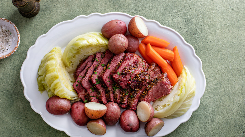 Corned beef with cabbage and potatoes on a serving platter, irish recipe idea for St Patrick's day