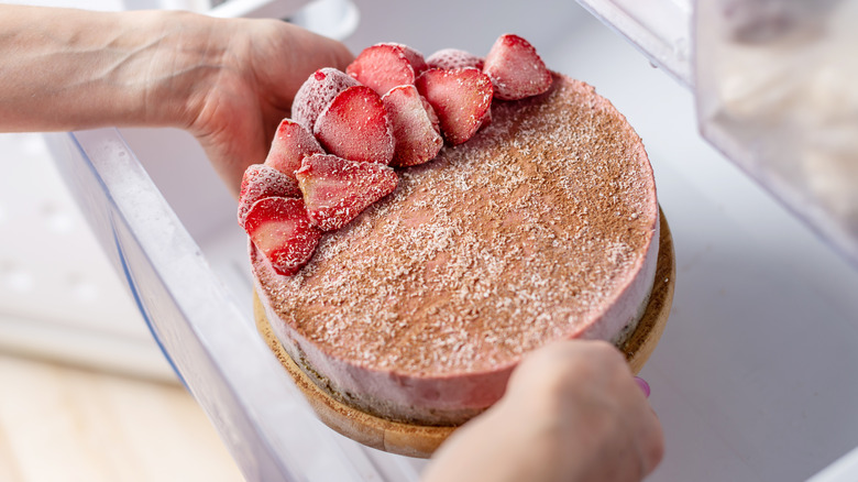 Person holding a frozen cake
