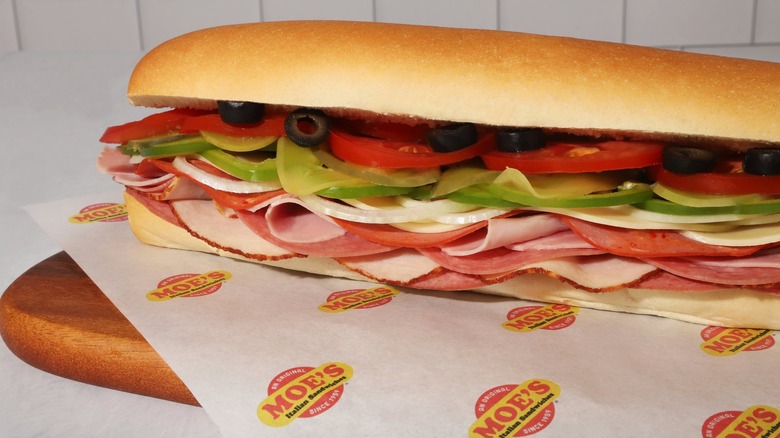 A sandwich from Moe's on Moe's-branded paper.