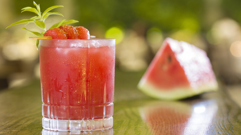 A watermelon cocktail sitting on a bar counter