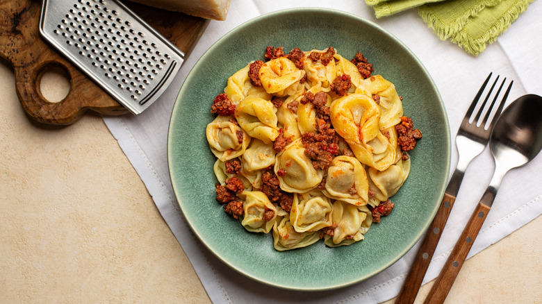 Plate of tortelloni with meat and tomato sauce