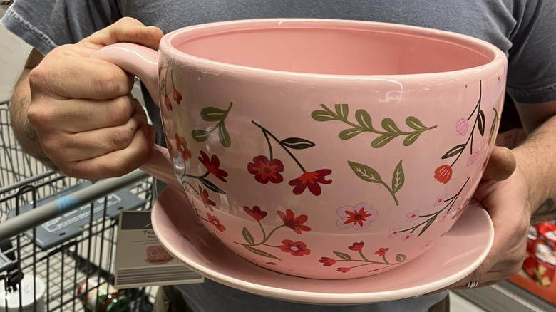 A man holds onto an Aldi teacup planter